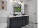 Modern bathroom featuring a double vanity with vessel sinks and stylish black and white flooring at 2138 Revolution Park Dr, Charlotte, NC 28208