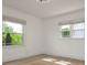 Bright, empty bedroom with hardwood floors and large windows providing natural light at 2138 Revolution Park Dr, Charlotte, NC 28208