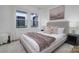 Cozy bedroom featuring a comfortable bed, neutral tones and natural light from a window at 2138 Revolution Park Dr, Charlotte, NC 28208