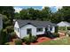 This home features eye-catching landscaping, black trim, and a cozy front porch at 2138 Revolution Park Dr, Charlotte, NC 28208