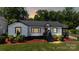 A lovely view of a home with eye-catching landscaping and a cozy front porch at 2138 Revolution Park Dr, Charlotte, NC 28208