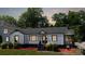 Charming one-story home with black and white trim, and a well-manicured front yard at 2138 Revolution Park Dr, Charlotte, NC 28208