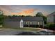 The exterior showcases a white siding home, black trim, and well-kept landscaping at 2138 Revolution Park Dr, Charlotte, NC 28208