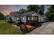 Charming one-story home with black and white trim and beautiful landscaped yard at 2138 Revolution Park Dr, Charlotte, NC 28208