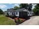 Eye-catching two-story home showcasing a screened front porch and pristine landscaping at 2138 Revolution Park Dr, Charlotte, NC 28208