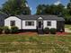 Charming single-story home with a tidy lawn, quaint front porch, and fresh exterior paint at 2138 Revolution Park Dr, Charlotte, NC 28208