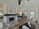 Open-concept living room featuring a brick fireplace and seamlessly flowing into a modern kitchen with a breakfast bar at 2138 Revolution Park Dr, Charlotte, NC 28208