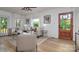 Spacious living room with wood floors, ample seating, decorative lighting, and large windows at 2138 Revolution Park Dr, Charlotte, NC 28208
