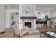 Living room features an accent fireplace, wood flooring and is open to the kitchen with barstool seating at 2138 Revolution Park Dr, Charlotte, NC 28208
