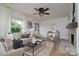 Inviting living room with ample natural light, a ceiling fan, fireplace and neutral color palette at 2138 Revolution Park Dr, Charlotte, NC 28208