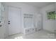 Charming mudroom features built-in bench and coat rack, providing storage and a welcoming entry at 2138 Revolution Park Dr, Charlotte, NC 28208