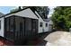 A beautifully updated home boasts a screened porch and a convenient driveway leading to a detached garage at 2138 Revolution Park Dr, Charlotte, NC 28208
