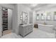 Bright bathroom features marble floors, soaking tub, and storage at 2200 Hastings Dr, Charlotte, NC 28207