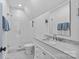 Pristine white bathroom featuring a glass-enclosed shower and marble countertop vanity with elegant fixtures at 2200 Hastings Dr, Charlotte, NC 28207
