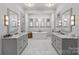 Bright bathroom features double sinks, marble floors, natural light, and a soaking tub at 2200 Hastings Dr, Charlotte, NC 28207