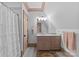 Comfortable full bathroom with shower, neutral tile, and light pink vanity at 2200 Hastings Dr, Charlotte, NC 28207