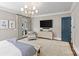 Spacious bedroom with a chandelier, carpet, natural light, and a TV at 2200 Hastings Dr, Charlotte, NC 28207