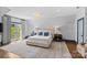 Bright main bedroom boasts ample natural light, neutral tones, and a cozy ambiance, perfect for relaxation at 2200 Hastings Dr, Charlotte, NC 28207