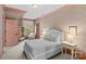 Inviting bedroom with pink trim, patterned wallpaper, and abundant natural light at 2200 Hastings Dr, Charlotte, NC 28207