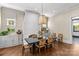 Bright dining room with a fireplace, hardwood floors, decor shelving, and a dark wood table at 2200 Hastings Dr, Charlotte, NC 28207