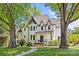 Stately white brick home featuring manicured landscaping and a welcoming entrance framed by mature trees at 2200 Hastings Dr, Charlotte, NC 28207
