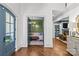 Inviting foyer showcasing hardwood floors and views into a green study and a blue and white living room at 2200 Hastings Dr, Charlotte, NC 28207