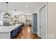 Bright kitchen with a large island, eat-in dining area, stainless appliances, hardwood floors, and white cabinetry at 2200 Hastings Dr, Charlotte, NC 28207