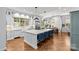 Bright kitchen with an oversized island, modern appliances, hardwood floors, and eat-in dining area at 2200 Hastings Dr, Charlotte, NC 28207