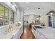 Spacious kitchen with a large island, stainless appliances, white cabinetry, and herringbone hardwood floors at 2200 Hastings Dr, Charlotte, NC 28207