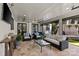 Inviting covered patio with comfortable seating, ceiling fan, and outdoor TV for relaxing and entertaining at 2200 Hastings Dr, Charlotte, NC 28207