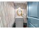 Stylish powder room features unique wallpaper and gold fixtures at 2200 Hastings Dr, Charlotte, NC 28207