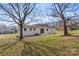 Backyard view of home featuring mature trees and green space at 2232 Glenraven Ave, Gastonia, NC 28052