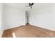 Empty bedroom featuring hardwood floors, a ceiling fan, and a large window at 2232 Glenraven Ave, Gastonia, NC 28052