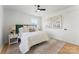 Bright bedroom features an upholstered headboard, ceiling fan, and neutral decor with two framed pictures above the bed at 2232 Glenraven Ave, Gastonia, NC 28052