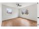 Bedroom with light hardwood floors, a ceiling fan, and two bright windows at 2232 Glenraven Ave, Gastonia, NC 28052