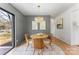 Cozy dining room with stylish chandelier and a view to the outside, creating a warm and inviting atmosphere at 2232 Glenraven Ave, Gastonia, NC 28052