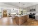 Bright living room and kitchen with an open layout, hardwood floors and stainless steel appliances at 2232 Glenraven Ave, Gastonia, NC 28052