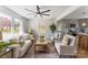 Bright living room with modern ceiling fan, neutral decor, and open layout to the kitchen at 2232 Glenraven Ave, Gastonia, NC 28052