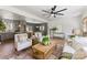Bright living room boasts an open concept with kitchen and dining area, stylish decor, and modern ceiling fan at 2232 Glenraven Ave, Gastonia, NC 28052