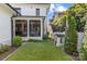 Grassy backyard featuring a small playhouse and partial view of covered patio on beautiful white brick home at 2316 Westminster Pl, Charlotte, NC 28207