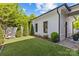 Landscaped backyard with neatly trimmed grass, a manicured garden bed, and a pristine white brick exterior at 2316 Westminster Pl, Charlotte, NC 28207