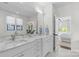 Bright bathroom with double sinks, marble countertops, and view into the bedroom at 2316 Westminster Pl, Charlotte, NC 28207