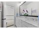 Bright bathroom with double sinks, marble countertops, and view to the stairway at 2316 Westminster Pl, Charlotte, NC 28207