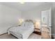 Serene bedroom with white bedding, natural light, and a view into the adjoining room at 2316 Westminster Pl, Charlotte, NC 28207