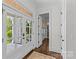 Bright foyer with tiled porch view, hardwood floors, and access to multiple rooms at 2316 Westminster Pl, Charlotte, NC 28207