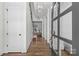 Bright hallway with hardwood floors, elegant lighting, and open view to dining area at 2316 Westminster Pl, Charlotte, NC 28207