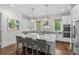 Elegant kitchen with an island, white cabinets, stainless steel appliances, and pendant lighting at 2316 Westminster Pl, Charlotte, NC 28207