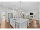 Open-concept layout showcasing the kitchen island, stainless steel appliances, and seamless flow to the living room at 2316 Westminster Pl, Charlotte, NC 28207