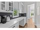 Bright kitchen featuring white cabinets, dark backsplash, quartz countertops, and modern appliances at 2316 Westminster Pl, Charlotte, NC 28207