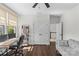 Office with dark wood floors, ceiling fan, desk, and view to the staircase at 2316 Westminster Pl, Charlotte, NC 28207